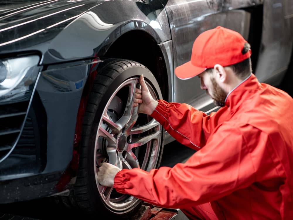 Changing a tyre on a grey car