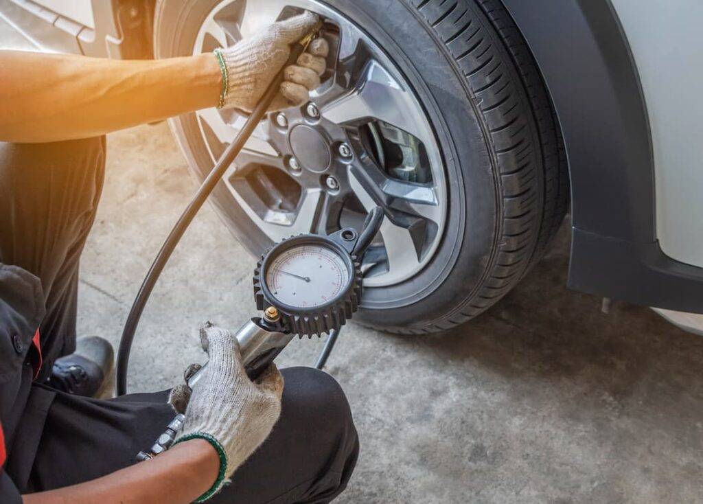 someone checking tyre pressure